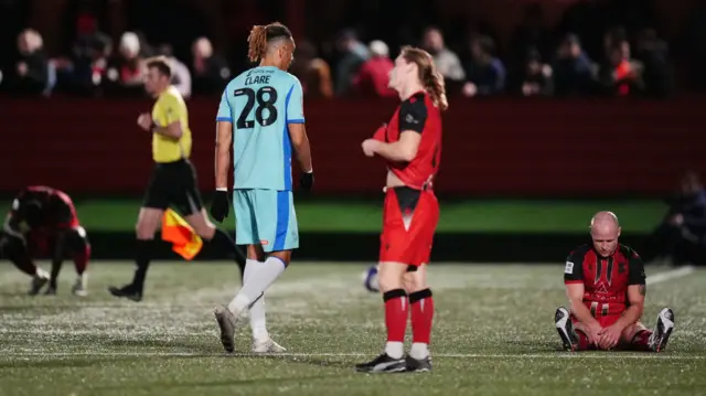 Tamworth players look dejected at full-time