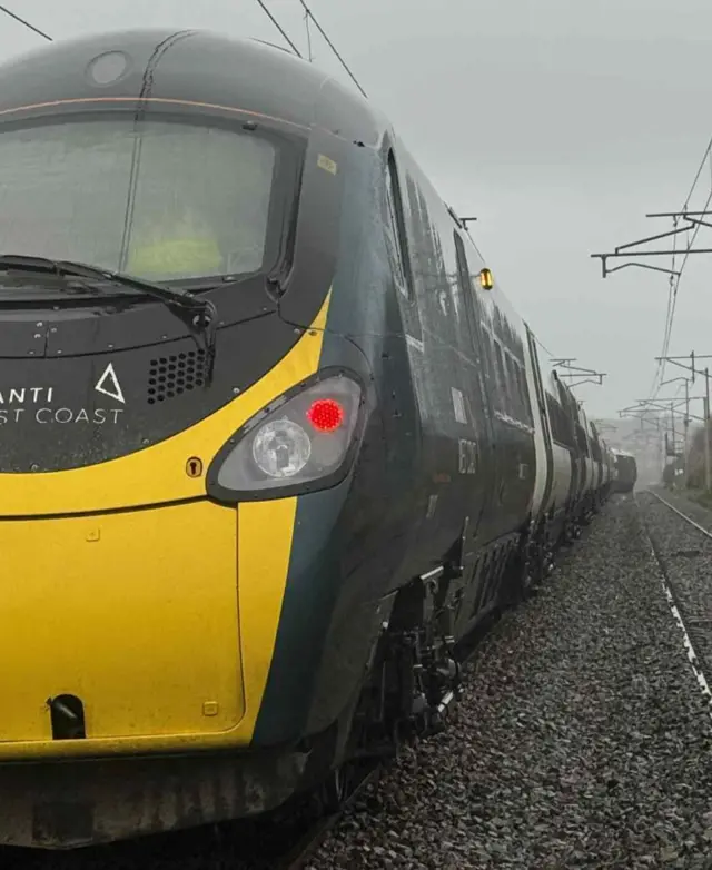 This picture, showing the other end of the train from our previous post, appears to show - in the distance - the front of the train off the tracks