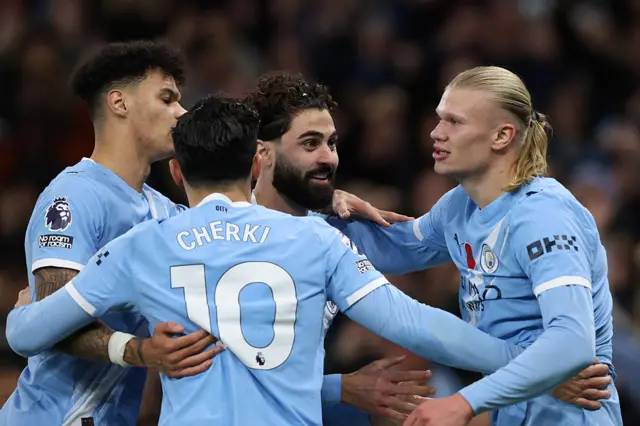 Erling Haaland is mobbed by Manchester City team-mates
