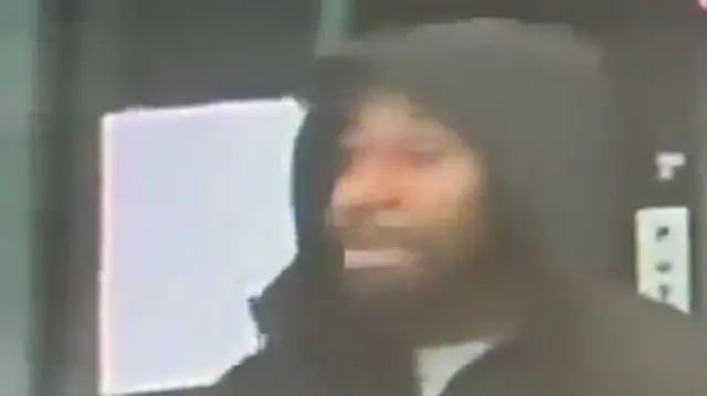 Anthony Williams pictured in a black coat with hood up, the image is blurry.