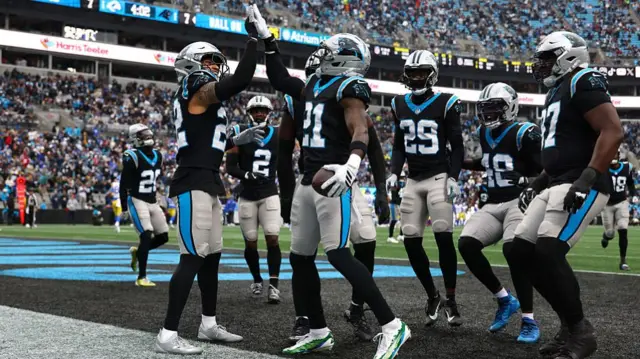 The Carolina Panthers defence celebrate after picking off Matthew Stafford in the endzone.