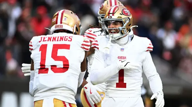 Juan Jennings celebrates with Ricky Pearsall after scoring a touchdown.