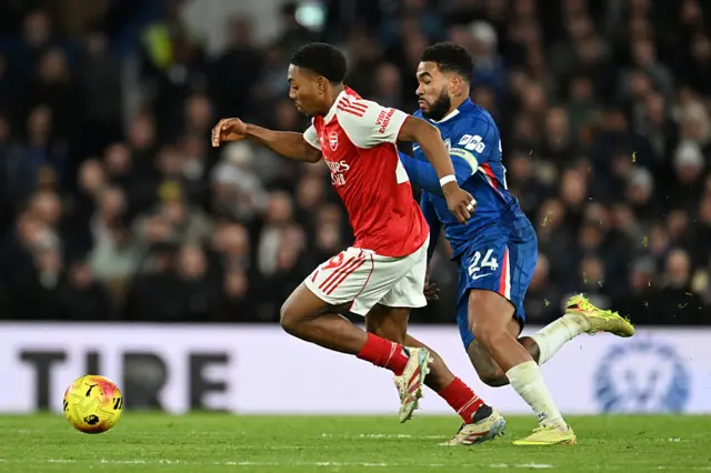 Reece James of Chelsea battles for possession with Myles Lewis-Skelly of Arsenal