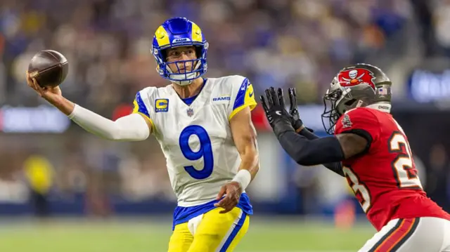 Matthew Stafford throws a side-arm pass while under pressure from a Tampa Bay Buccaneers defender