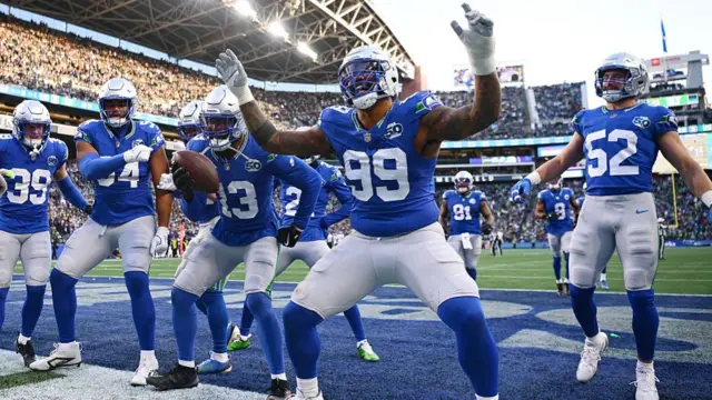 The Seattle Seahawks defence celebrate after picking off Max Brosmer