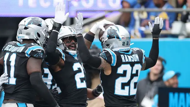Nick Scott celebrates with his team-mates after intercepting Matthew Stafford.