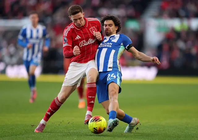 Ferdi Kadioglu of Brighton is challenged by Elliot Anderson of Nottingham Forest