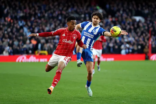 Omari Hutchinson of Nottingham Forest battles for possession with Ferdi Kadioglu of Brighton