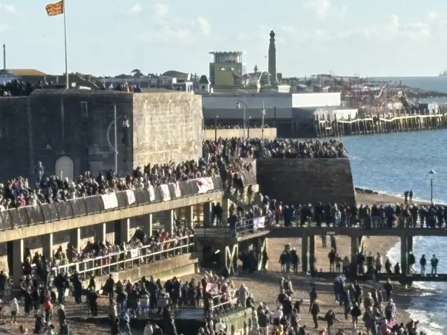 Crowds of people line the walls in Portsmouth