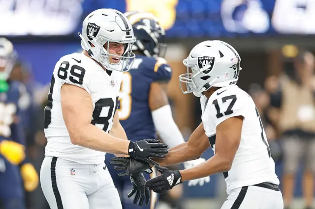 Brock Bowers celebrates with Tyler Lockett