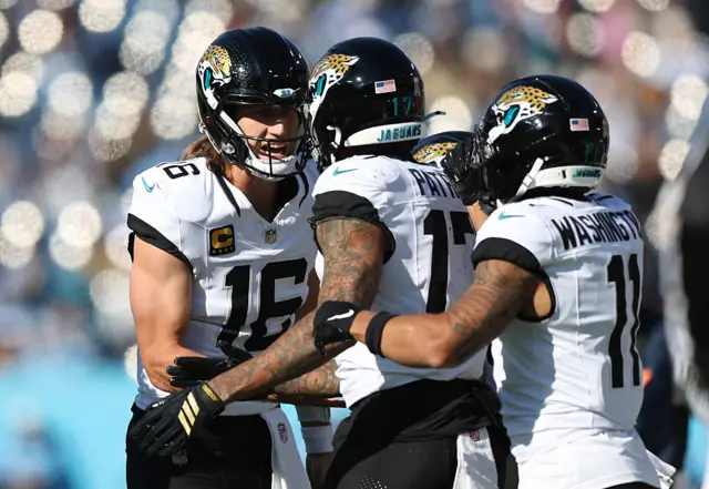Trevor Lawrence celebrates with his Jacksonville Jaguars teammates