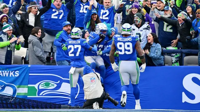 Ernest Jones IV #13 of the Seattle Seahawks celebrates with fans after returning an interception for a touchdown against the Minnesota Vikings in the second quarter of a game at Lumen Field