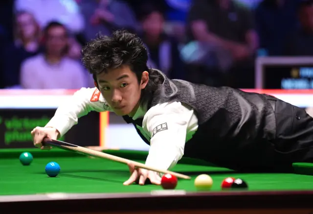 Wu Yize on his way to winning his match against Michael Holt,