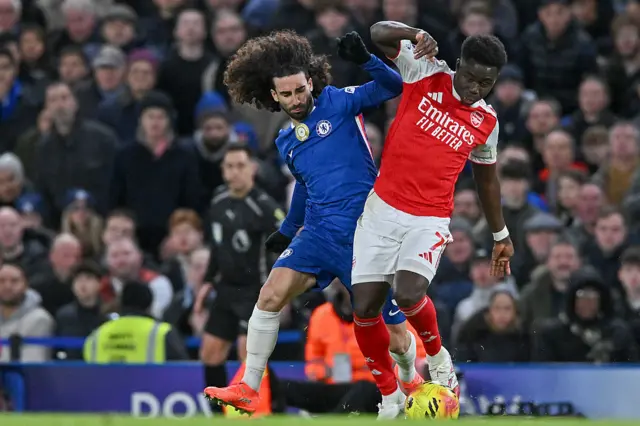 Marc Cucurella of Chelsea battles with Bukayo Saka of Arsenal