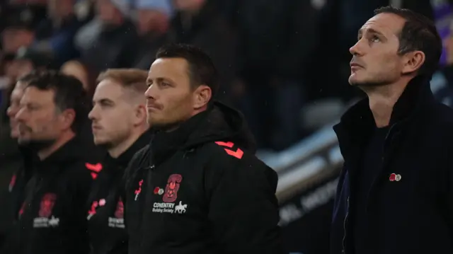 Frank Lampard and his staff observe a minute's silence before kick-off