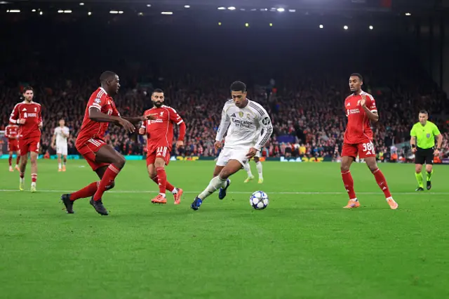 Jude Bellingham of Real Madrid cuts through the Liverpool defence