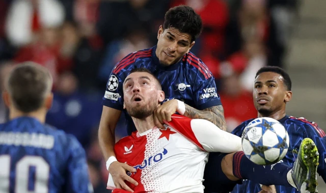 Slavia Prague's Tomas Chory in action with Arsenal's Piero Hincapie and Gabriel Magalhaes