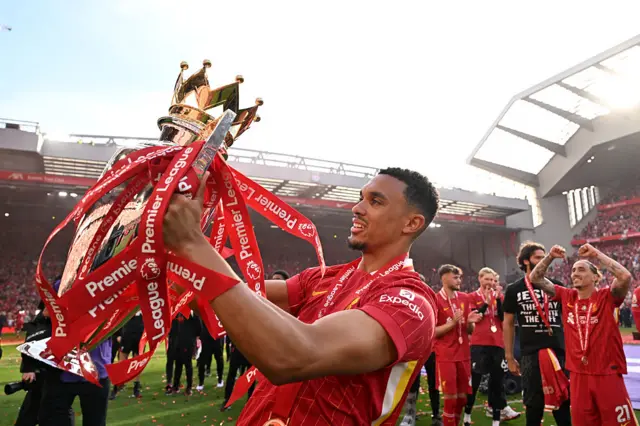 Trent Alexander-Arnold holding the Premier League trophy