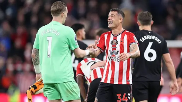 Granit Xhaka and Everton goalkeeper Jordan Pickford