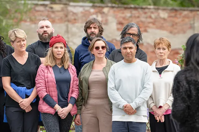 Faithfuls lined up in athletic wear while Claudia Winkleman addresses them