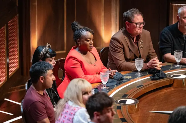 A scene from the Celebrity Traitors roundtable, where Tameka and Alan look on nervously