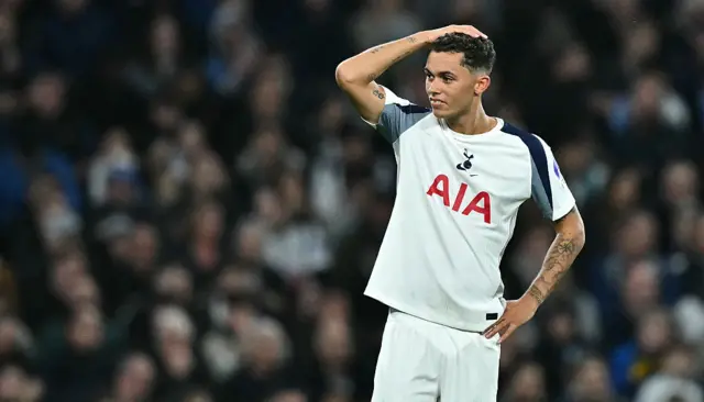 Brennan Johnson puts his head in his hands as the referee upgrades his decision to red.