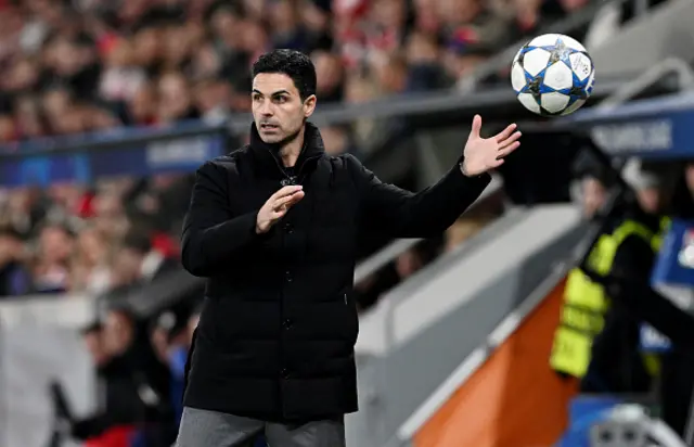 Mikel Arteta, Manager of Arsenal, retrieves the match ball