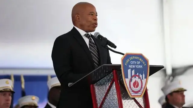 Current New York City Mayor Eric Adams. Eric Adams, mayor of New York City, stands behind a lectern with a Fire Department of New York sign on it