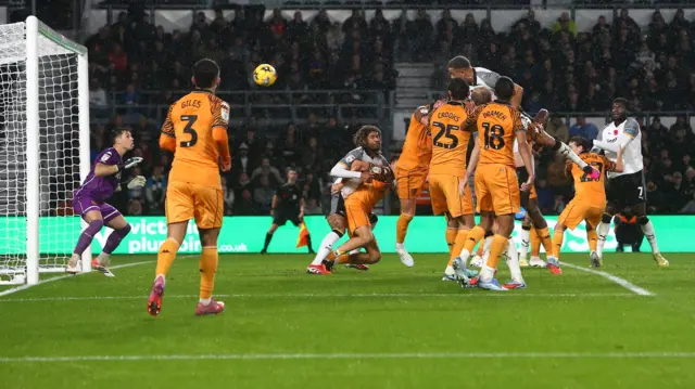 Carlton Morris rises to meet a corner and score for Derby