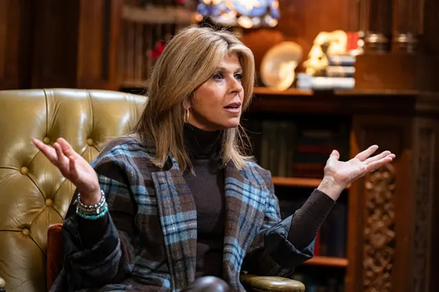 Kate Garraway sat in an armchair with her hands out wide