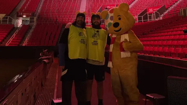 Lee Blakeman and Ajmal Hussain wearing Children in Need t shirts and Pudsey ears inside the Bet365 Stadium