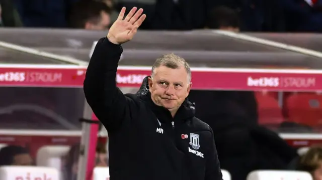 Mark Robins waves to the fans