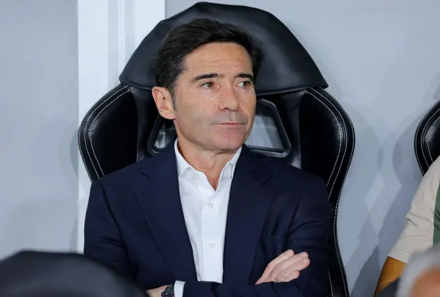 Marcelino sits on the bench with his arms folded