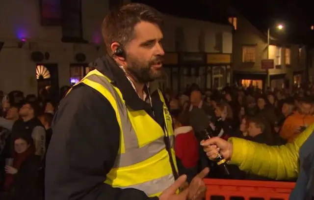Event steward in a high vis vest.