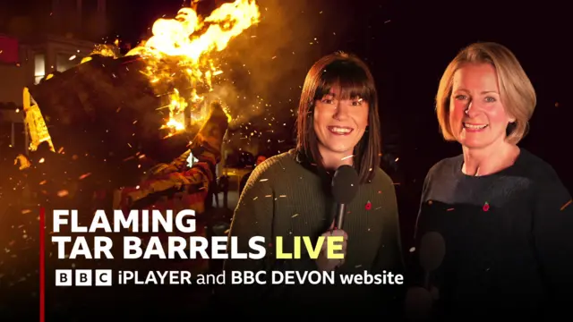 Erin Black, who has black hair and is wearing a green jumper, and Victoria Graham, who has blonde hair and is in a blue shirt. Behind them is a flaming tar barrel.