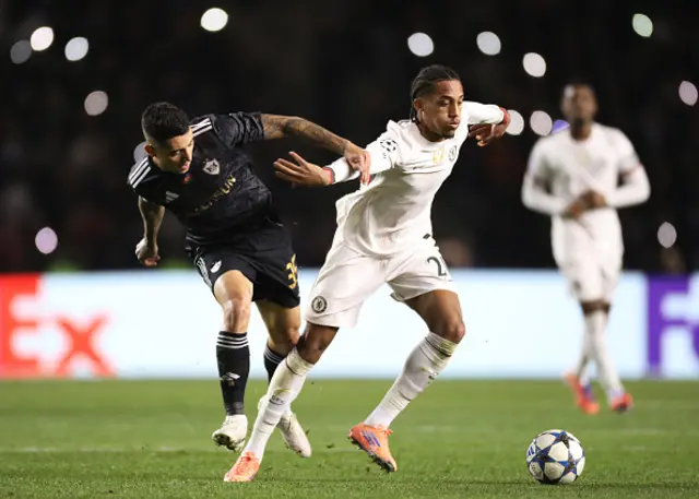 Joao Pedro of Chelsea is challenged by Pedro Bicalho