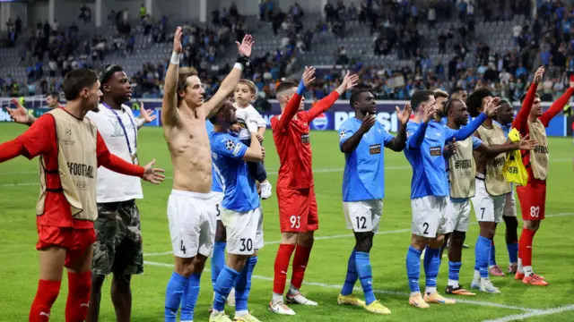 Pafos FC players celebrate their landmark win in front of their fans