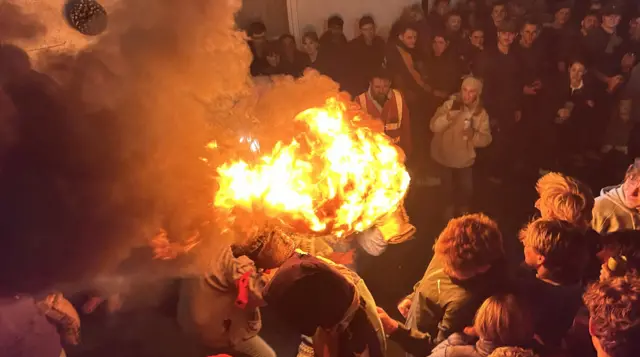 A flaming inferno is seen going through the crowd.