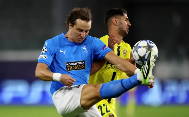 Luiz clears the ball under pressure