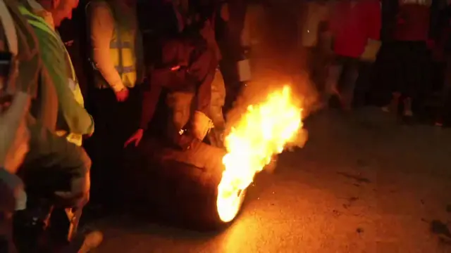 A close-up of a flaming tar barrel.