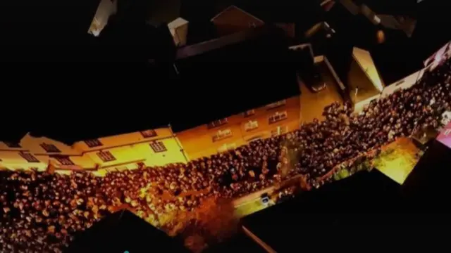 Crowds of people line the streets