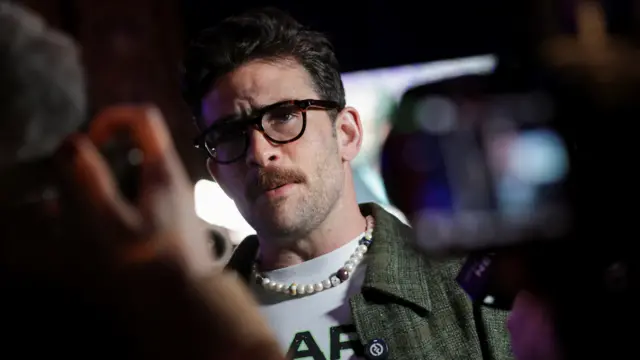 Hasan Piker speaks to members of the media