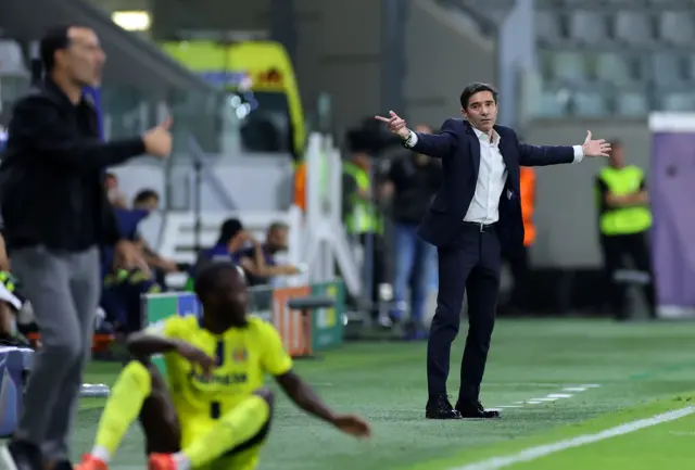 Marcelino waves his arms in the air