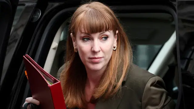 Former Deputy Prime Minister Angela Rayner getting out of a vehicle while holding a binder.