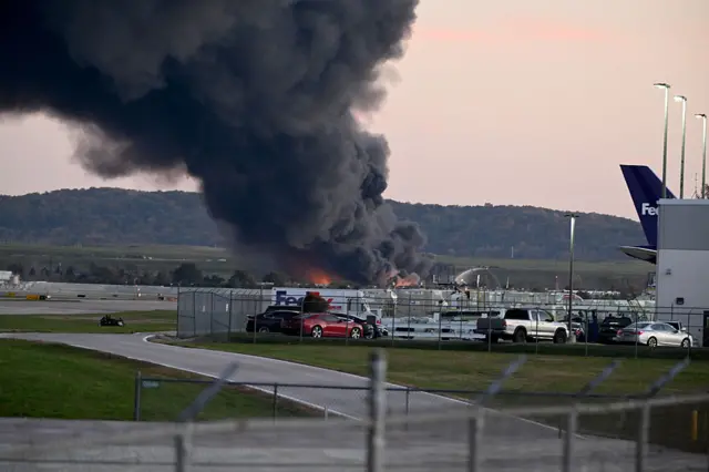 Fire and smoke can be seen, marking where a UPS cargo plane crashed near Louisville Muhammad Ali International Airport