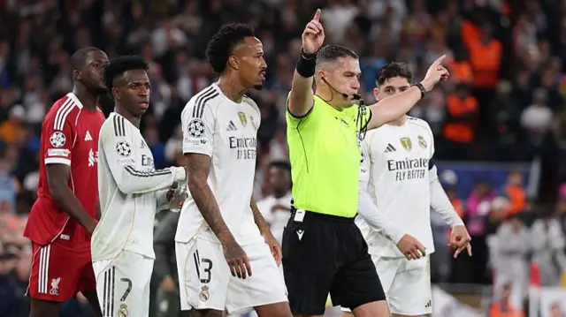 Referee Istvan Kovacs signals for VAR