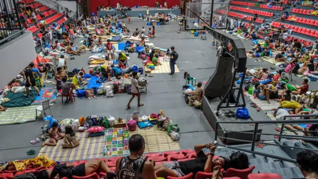 Families affected by typhoon Kalmaegi stay at a sports complex used as an evacuation centre in Cebu Province, Philippines.