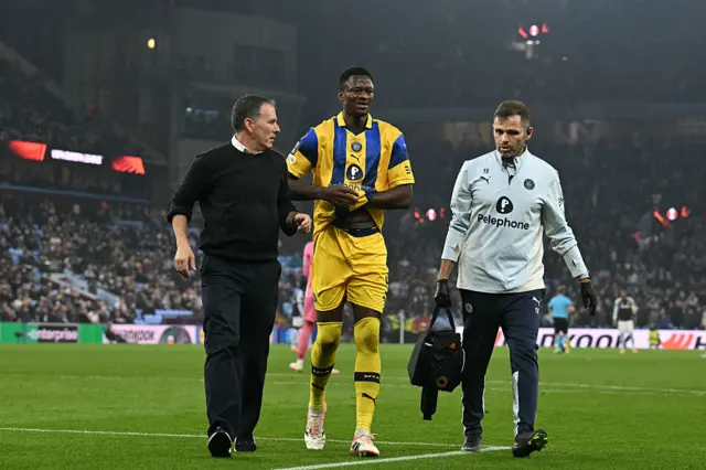Maccabi Tel Aviv's Guinean defender #05 Mohamed Ali Camara leaves the pitch injured early in the first half during the UEFA Europa League league-stage football match between Aston Villa and Maccabi Tel Aviv at Villa Park in Birmingham on November 6, 2025.