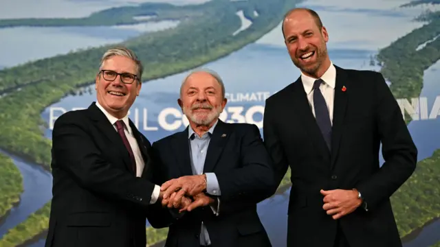 Brazil's President Luiz Inacio Lula da Silva, Britain's Prime Minister Keir Starmer and Britain's Prince William hold each other's hands on the sidelines of the Belem Climate Summit of the United Nations Climate Change Conference (COP30), in Belem, Brazil, November 6, 2025.