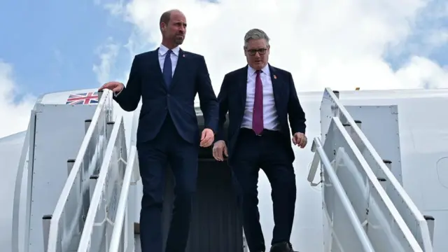 Prince William and Keir Starmer leaving a plane together.